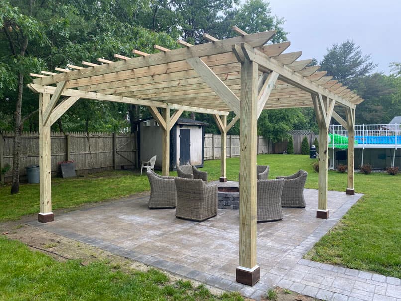 Custom wood pergola with seating area built by C&J General Services
